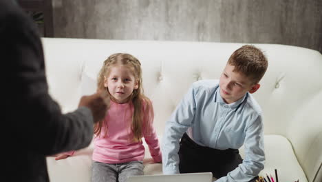 girl and boy look at cards and answer teacher questions