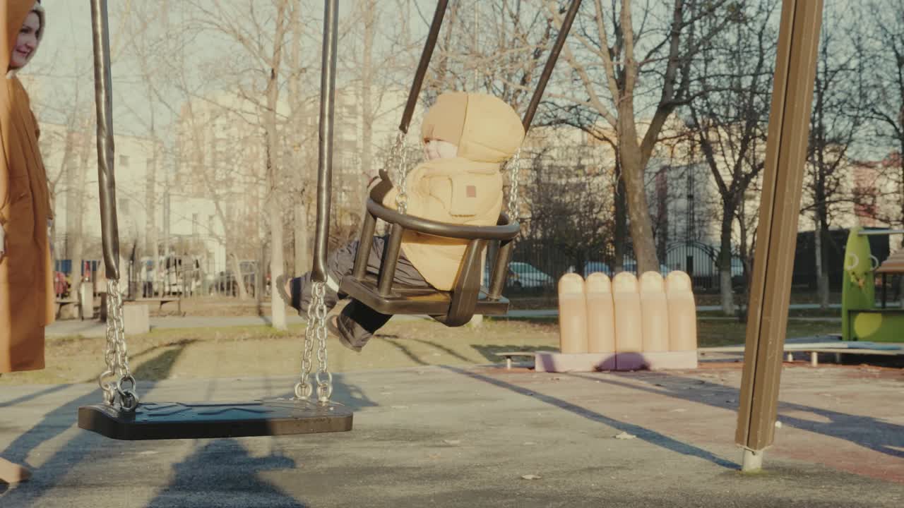 Child having fun on a swing at the playground