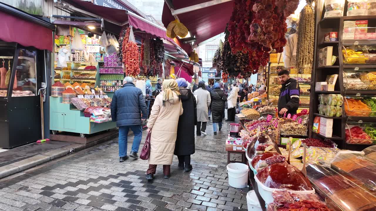 A bustling market scene with people and colorful displays of food