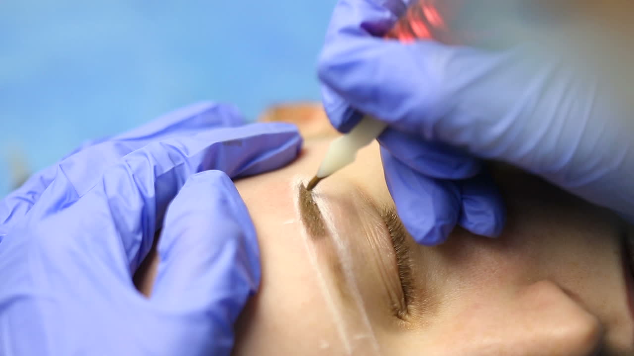 Cosmetician working eyebrow make up at beauty-farm