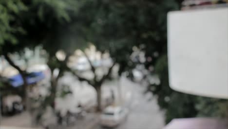 Blurred-shot-of-a-street-with-traffic,-people-and-cars-are-passing-in-background