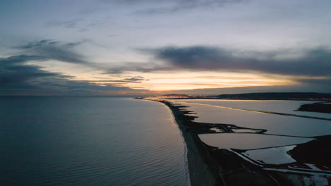 Sunset-over-the-Mediterranean-sea-along-canal-du-Rhone-aerial-drone-view