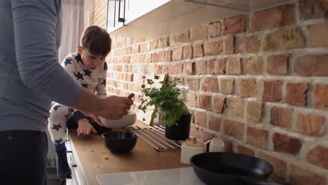 video of father and son using mobile phone while breakfast