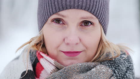 Young-Woman's-Face-In-Warm-Scarf-Against-Snow-Covered-Park