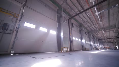 construction process of a big, modern warehouse with multiple garage gates for easy access and transportation of goods.