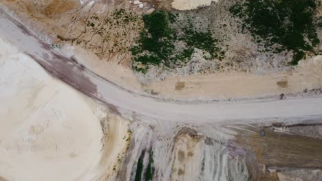 gravel road in sand quarry, aerial top down view