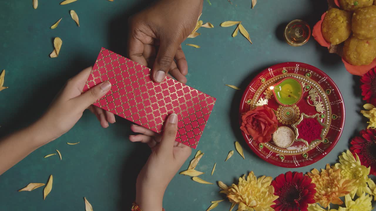 Brother Gifts Sister Money for Rakhi in Top Down Scene, Slow Motion