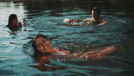 friends swimming in a lake