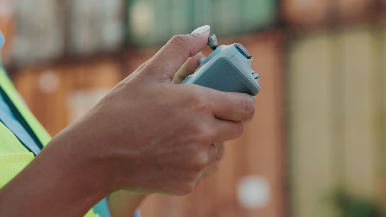 Person operating a drone controller in a warehouse