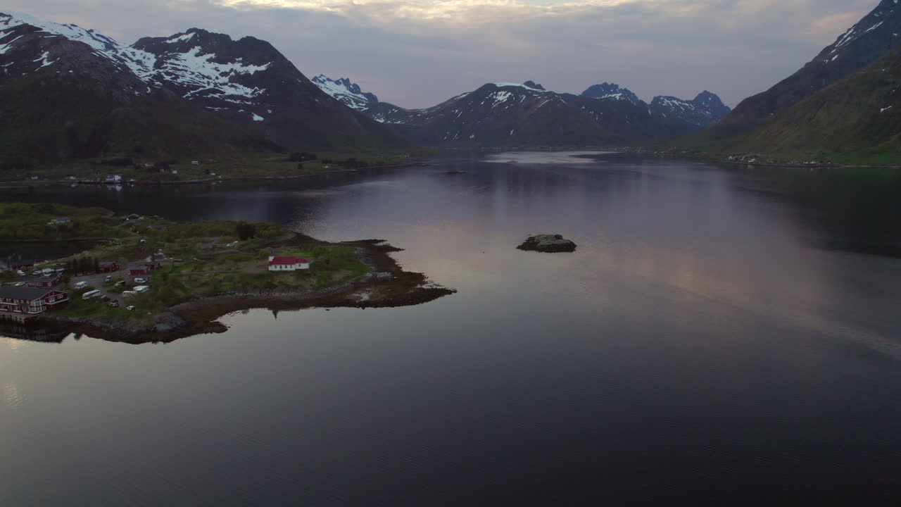 Austnesfjorden in de schemering: Dramatische bergen met witte toppen.