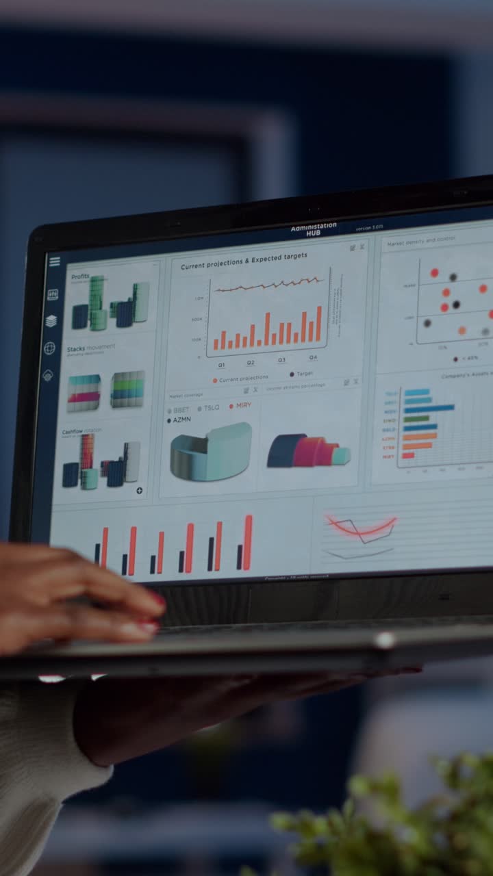 Vertical video Close up of dark skin woman typing on laptop standing in start up office