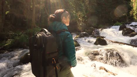 hiking woman walk with a hiking backpack in spring green forest