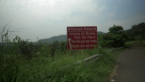 Static-shot-of-escape-ramp-on-the-left-side-on-the-highway-carved-through-mountain