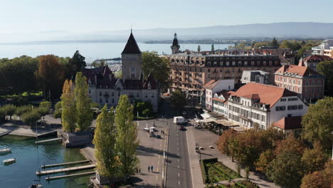 aerial of bus on street and tilting up to church in lausanne, switzerland