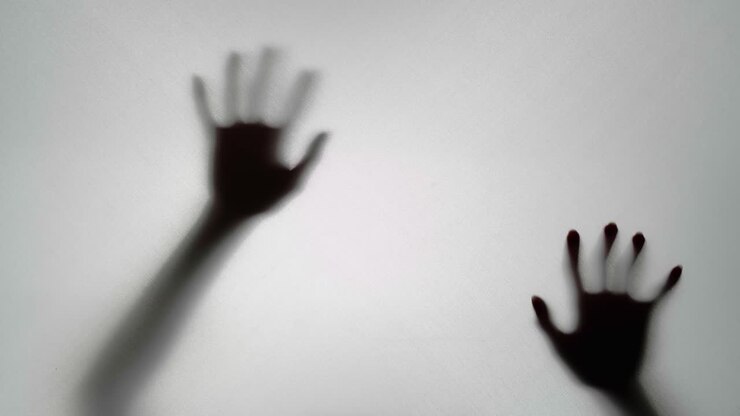 Silhouette of Hands Reaching Through a Semi-Transparent Surface