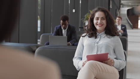 portrait of biracial businesswoman working on tablet