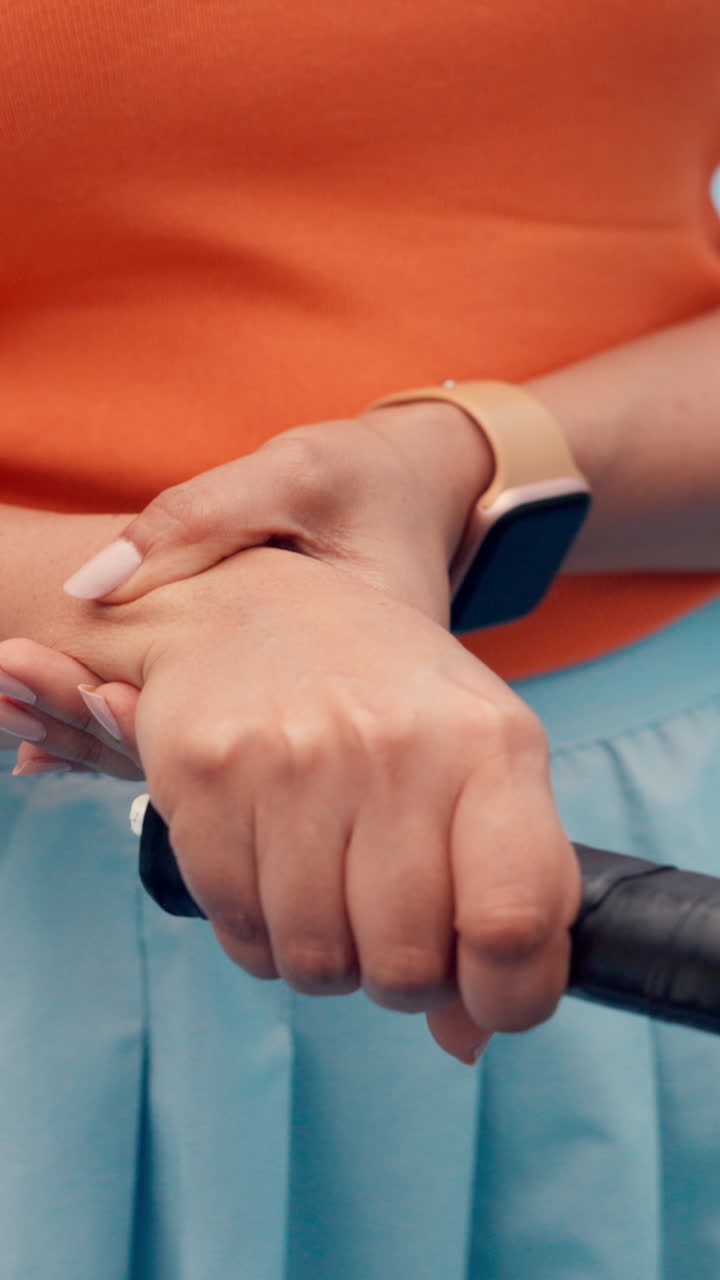 Close-up of a Tennis Player's Hands Holding a Racket