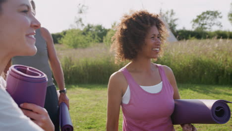 Female-Teacher-Shaking-Hands-With-Mature-Men-And-Women-In-Class-At-Outdoor-Yoga-Retreat