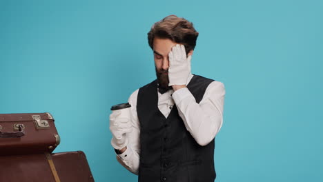 doorman poses with coffee cup in studio