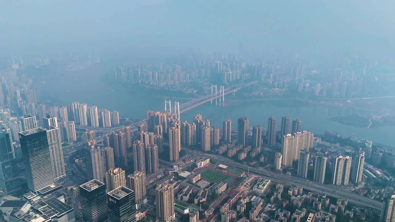 High altitude drone view of Chongqing city shrouded in extreme pollution and smog, capturing the dense urban landscape, high-rise buildings, and the river fading into the haze. China