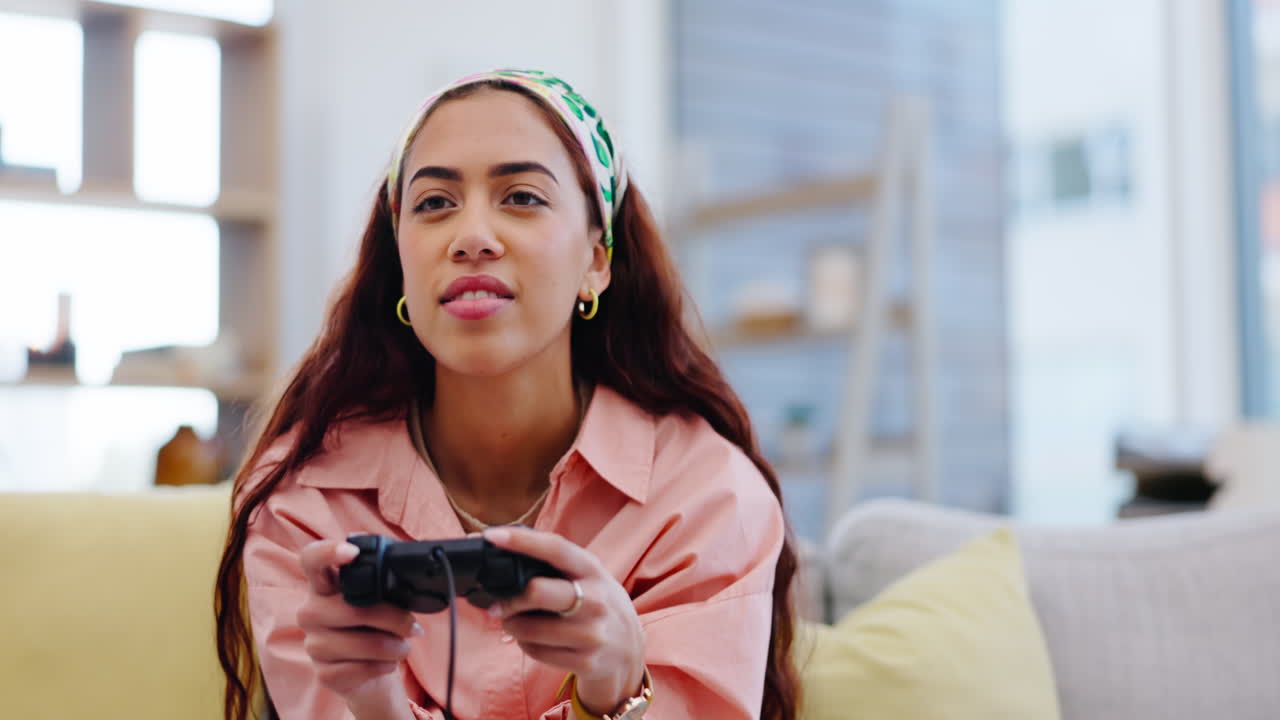Woman on sofa playing video games