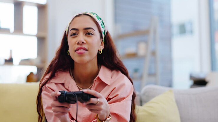 Woman on sofa playing video games