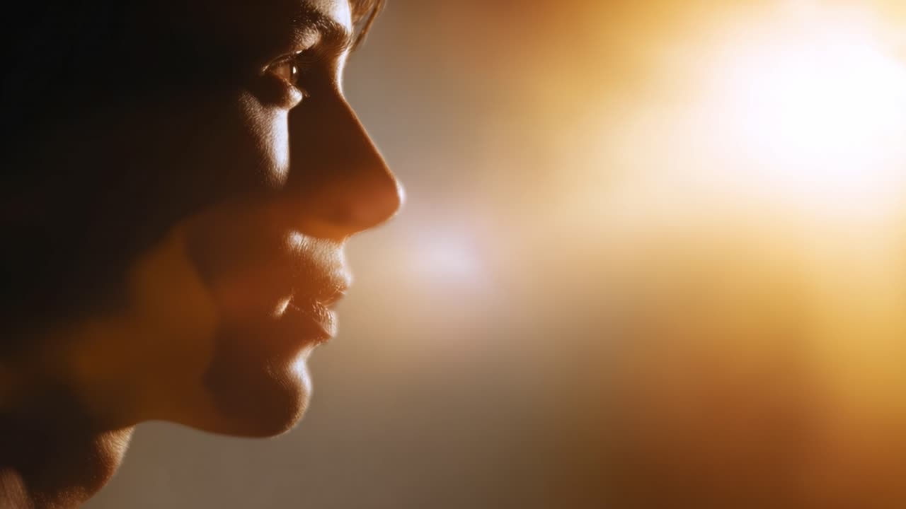 A captivating silhouette of a person's profile illuminated by a warm, glowing light creates a striking contrast that reflects moments of introspection and serenity