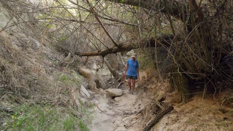 Female-hiker-explores-rock-cave-Rose-valley-trail-Cappadocia