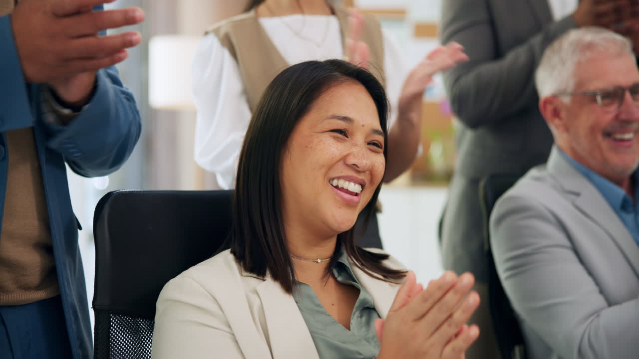 Happy Businesswoman Clapping and Smiling in an Office Meeting