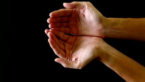 male hands gesture on black background.