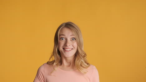 caucasian woman looking up and getting surprised on camera.