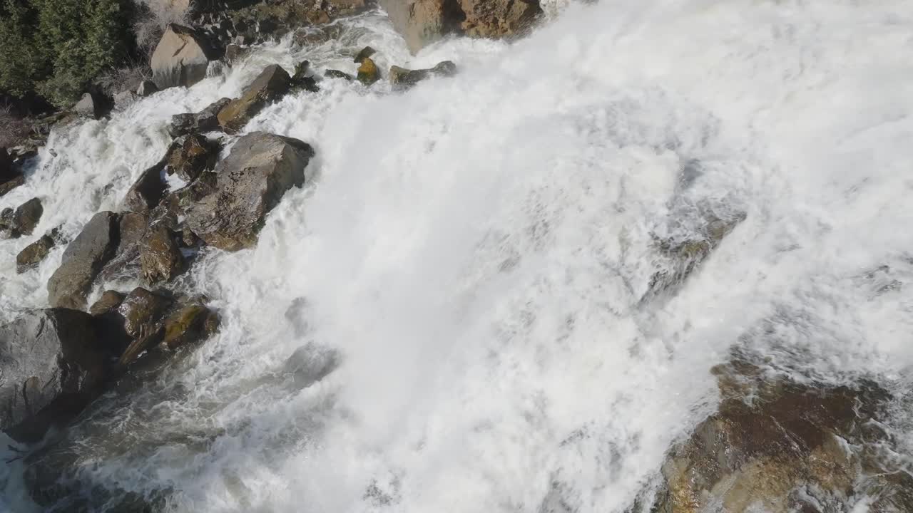 Rushing waterfall cascades over rocky terrain in Owen Sound, Canada, captured from above