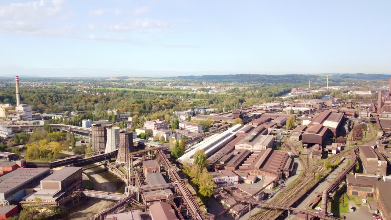 Steel factory complex and rooftops of Trinec industrial area in Czech Republic, panoramic aerial dolly