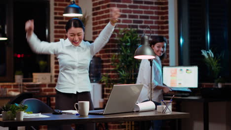 Employee-receiving-amazing-news,-throwing-hands-in-air-in-celebration