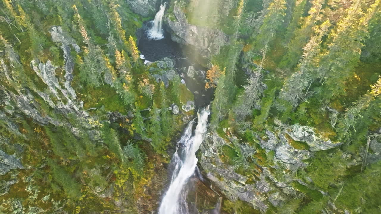 Sunlight Shining Through The Forest And Waterfalls In The Mountain