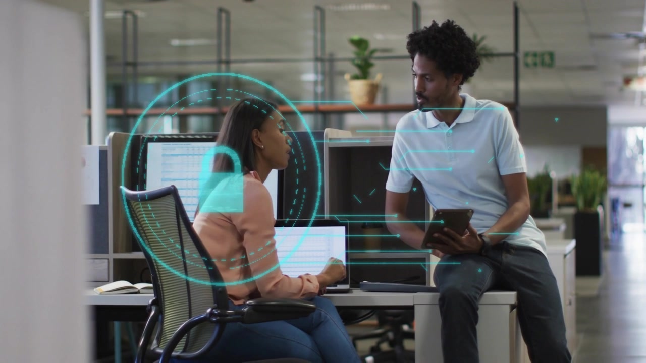 Business People Discussing Data on Laptop with Digital Security Overlay