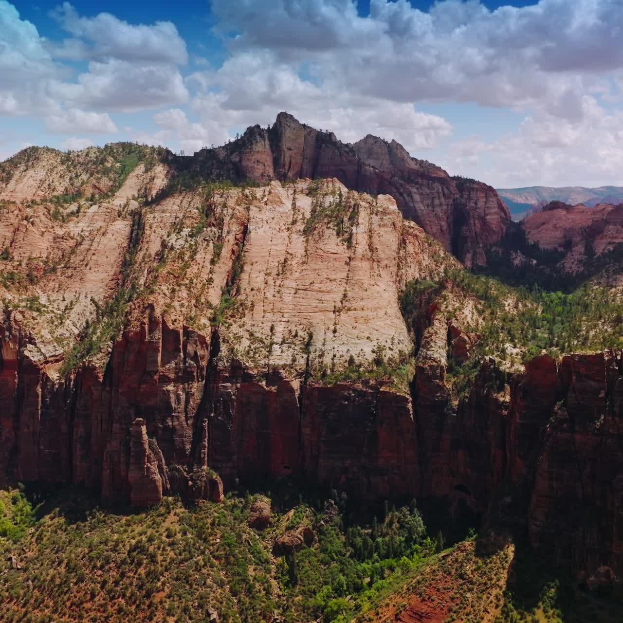 Tremendous rocks of Zion National Park on beautiful sunny day. Beautiful blue skies with lovely clouds at backdrop. Aerial view