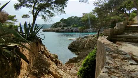 hiking trail on the coast of cala gat in cala ratjada with stone wall in good weather in the nature of palma de mallorca