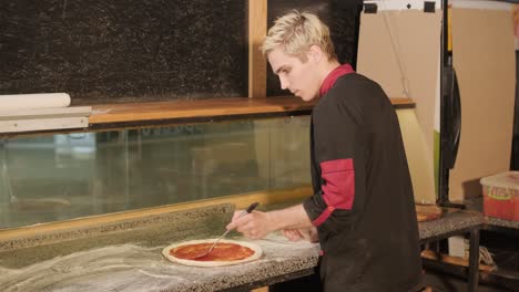 chef preparing pizza toppings in a restaurant kitchen