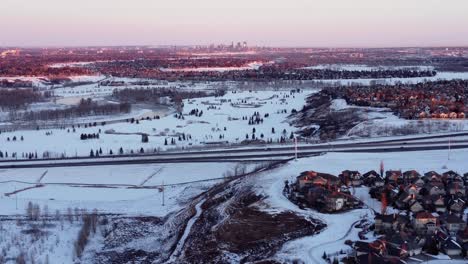 aerial shots of calgary's snow-covered mountains during a beautiful winter sunrise