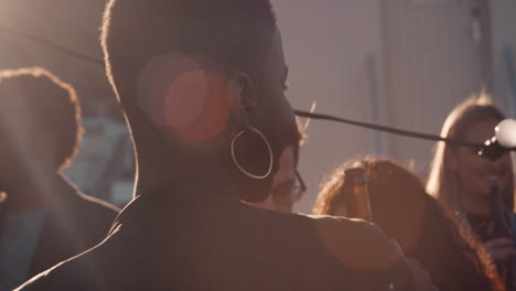 group-of-diverse-friends-hanging-out-beautiful-african-american-woman-dancing-enjoying-rooftop-party-at-sunset-drinking-alcohol-having-fun-on-weekend-celebration