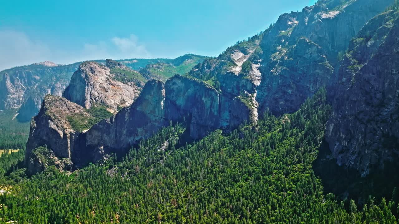 View of Yosemite Valley with evergreen forests visible in the background