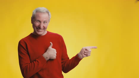 smiling senior man pointing