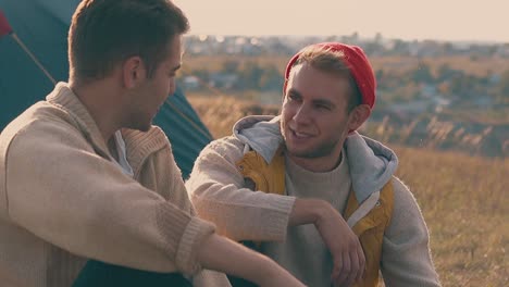 hiker talks to boyfriend resting at blue tent slow motion