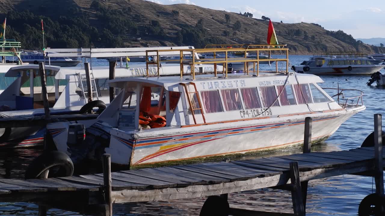 Empty tour boat waits for tourist passengers at marina in Puno, Peru