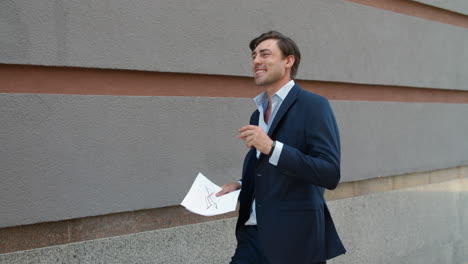 Business-man-dancing-in-suit.-Businessman-celebrating-victory-outdoor