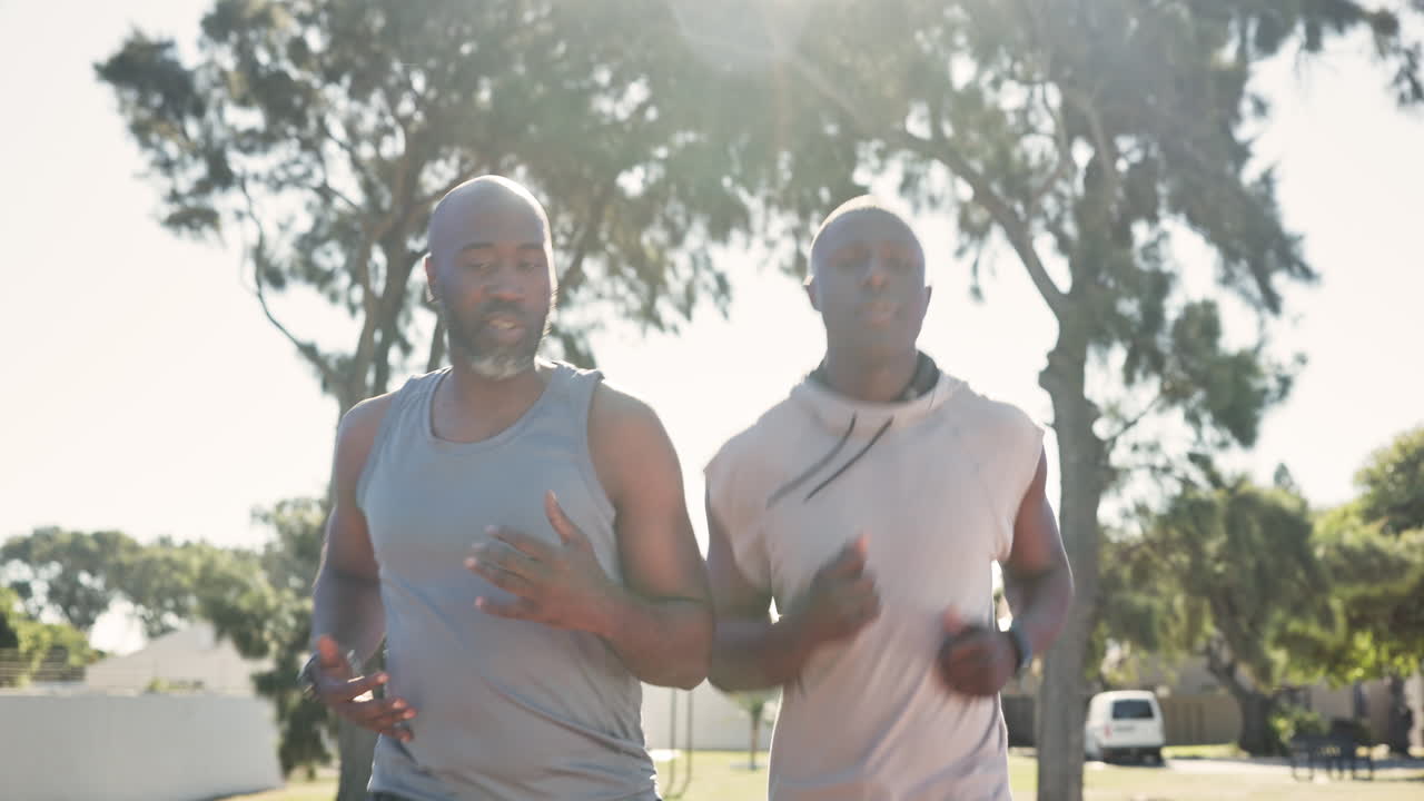 Two African American men jogging in a park