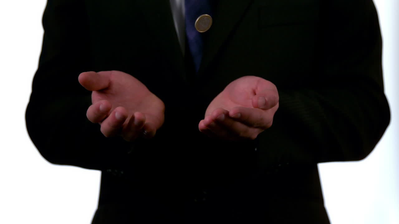 사업가 가 손 에 동전 을 던지고 잡는 것