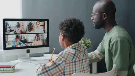 Niño-Afroamericano-Estudiando-En-Línea-Con-La-Ayuda-De-Papá-En-Casa