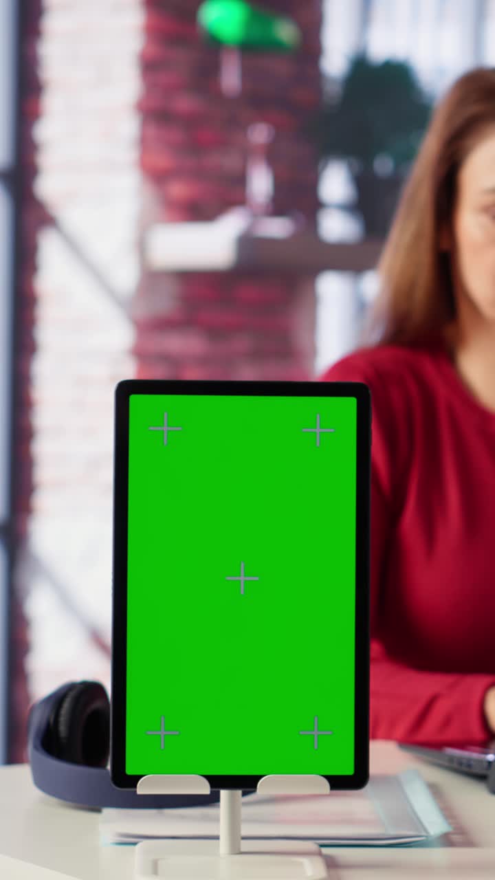Vertical Video Confident woman solving her tasks on a freelance platform next to mockup screen